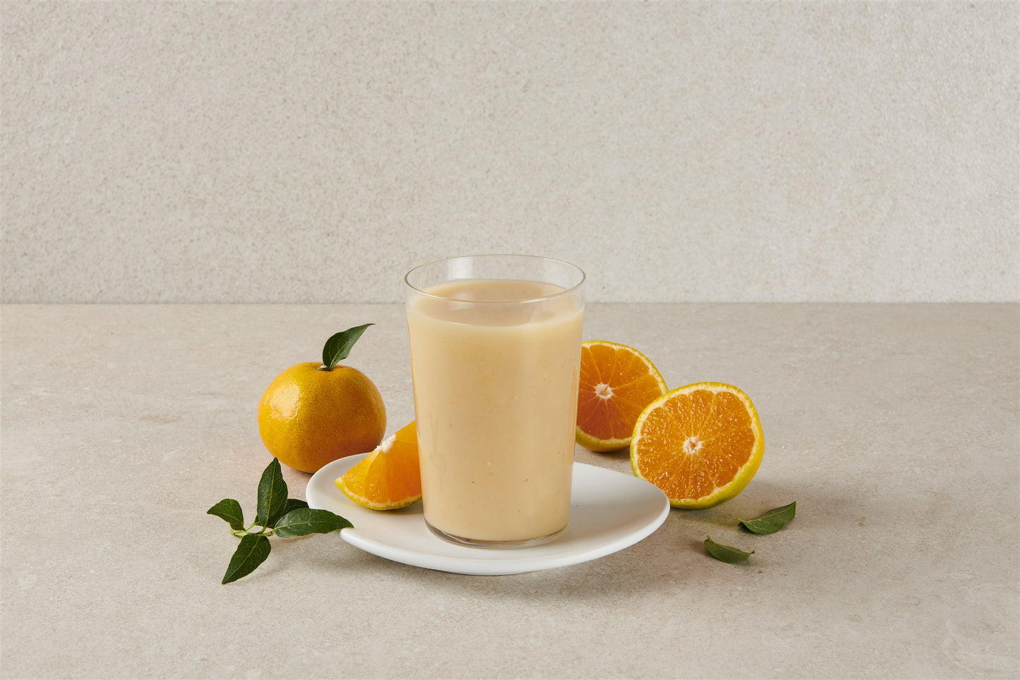 A glass of Jeju tangerine Swindari with fresh Jeju tangerines, studio shot